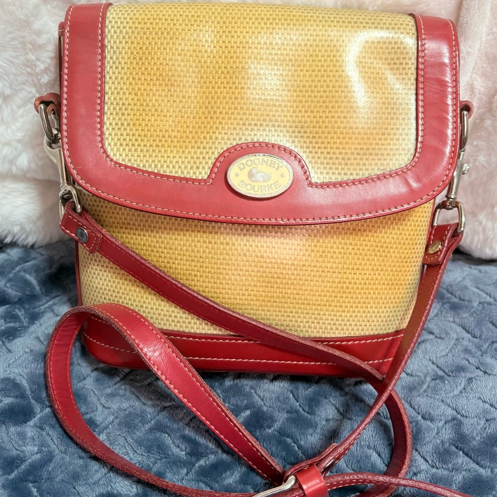 vintage Dooney & Bourke crossbody bag with a red leather trim and a woven straw